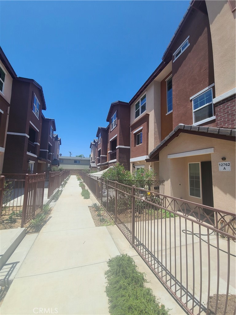 12766 Torch Street, Unit B Baldwin Park, CA 91706 - Photo 1 of 13 a view of a house with wooden fence