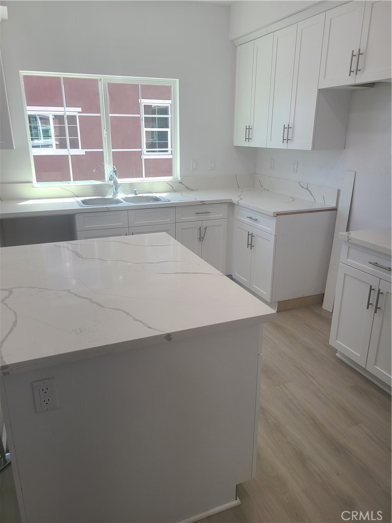 12766 Torch Street, Unit B Baldwin Park, CA 91706 - Photo 9 of 13 a kitchen with a cabinets and white appliances