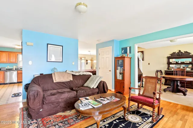 a living room with furniture and a bookshelf
