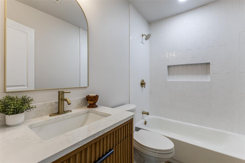 3719 Dutton Drive Dallas, TX 75211 - Photo 17 of 24 a bathroom with a sink a toilet and shower