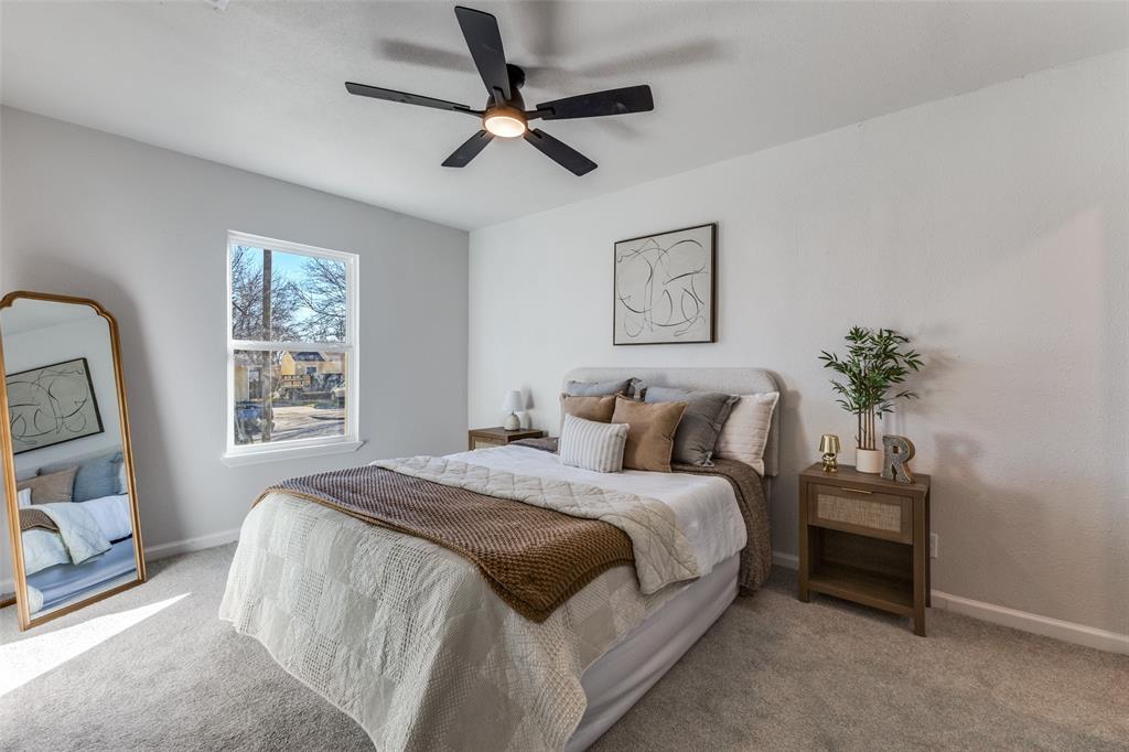 3719 Dutton Drive Dallas, TX 75211 - Photo 18 of 24 a bedroom with a large bed and a chandelier