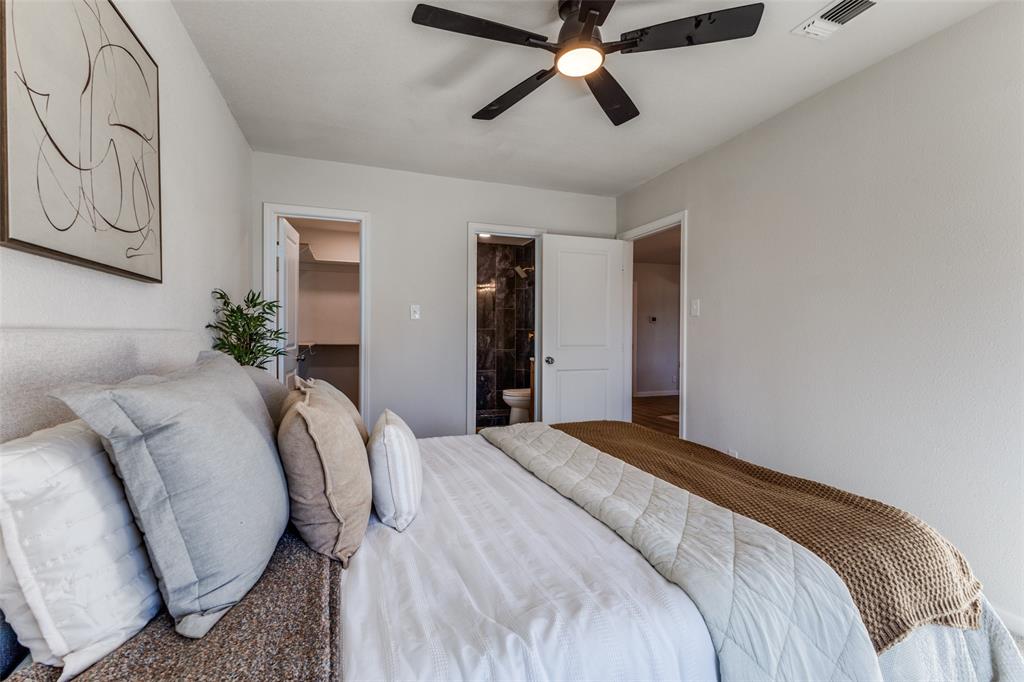 3719 Dutton Drive Dallas, TX 75211 - Photo 19 of 24 a bedroom with a bed and a chandelier
