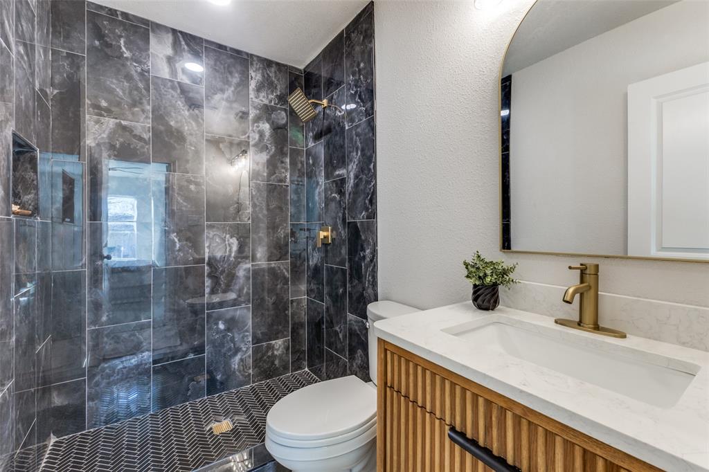 3719 Dutton Drive Dallas, TX 75211 - Photo 20 of 24 a bathroom with a sink a toilet and shower