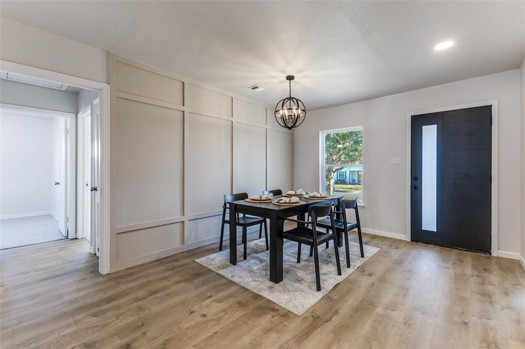 3719 Dutton Drive Dallas, TX 75211 - Photo 2 of 24 a view of a dining room with furniture window and wooden floor