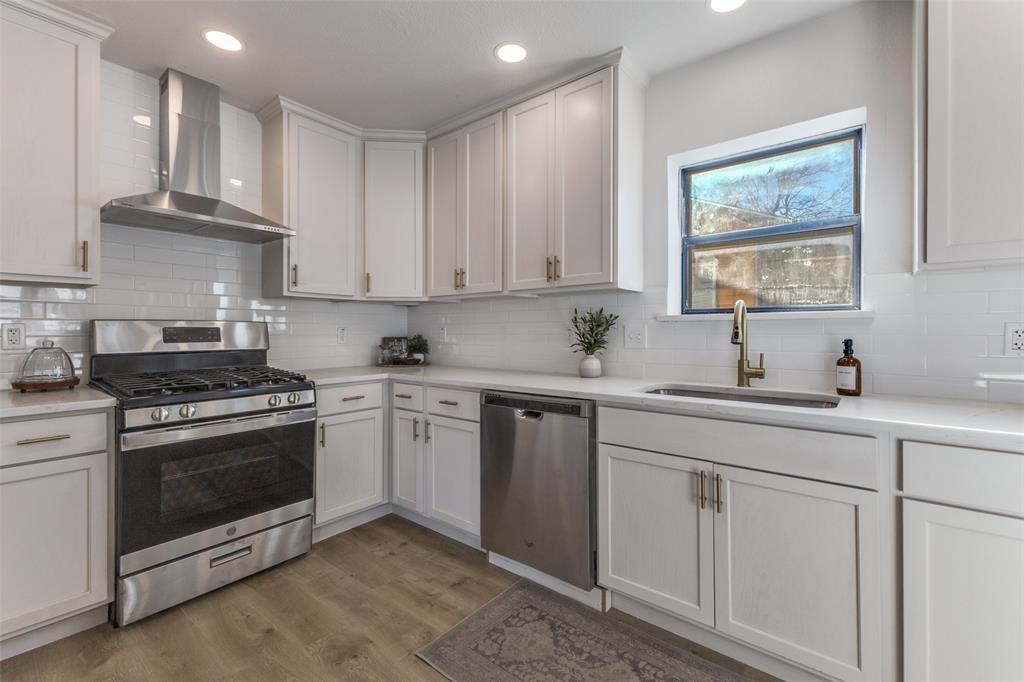 3719 Dutton Drive Dallas, TX 75211 - Photo 23 of 24 a kitchen with cabinets appliances a sink and a window