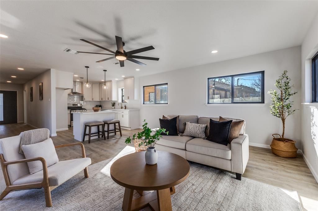 3719 Dutton Drive Dallas, TX 75211 - Photo 4 of 24 a living room with furniture a chandelier and a potted plant