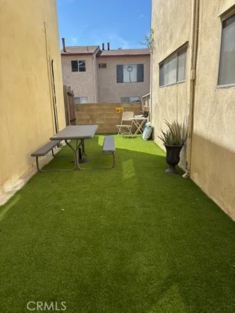 a view of backyard of the house with outdoor seating
