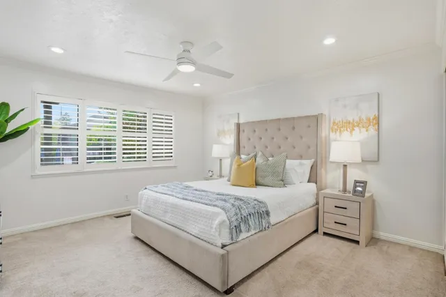 a bedroom with a large bed and a chandelier