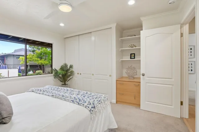 a spacious bedroom with a bed and a window