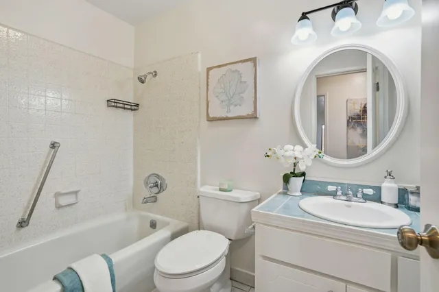 a bathroom with a toilet sink and a mirror