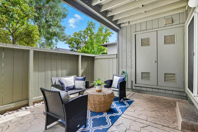 a view of a patio with couple of chairs and a couch