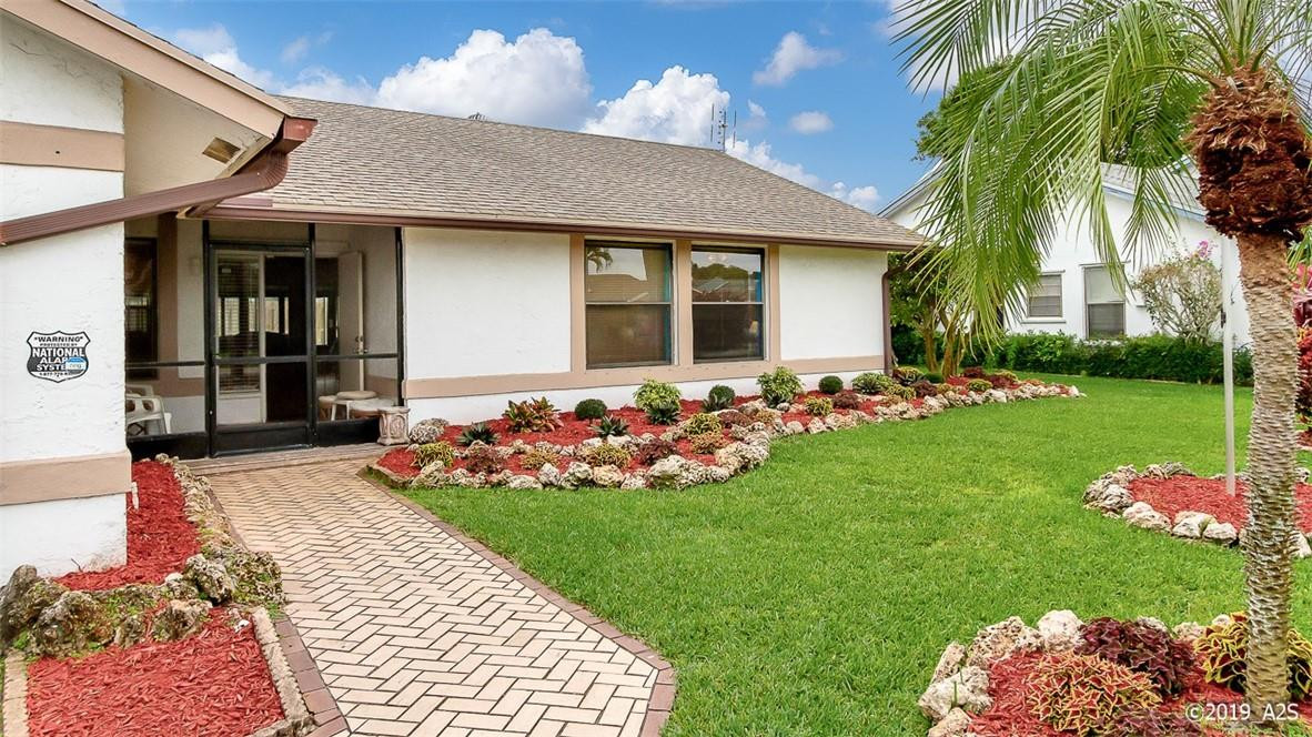 9612 Ohio Place Boca Raton, FL 33434 - Photo 6 of 26 a front view of a house with garden