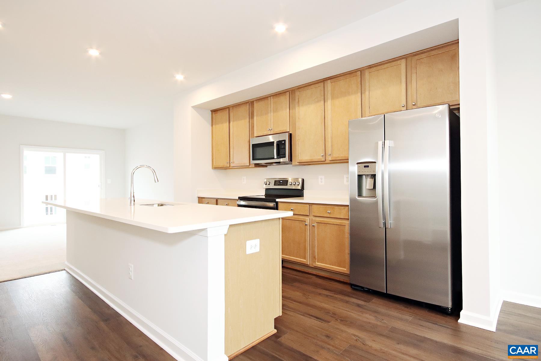 5997 McComb Street Crozet, VA 22932 - Photo 6 of 27 a kitchen with stainless steel appliances granite countertop a refrigerator a sink a stove a microwave and island with wooden floor