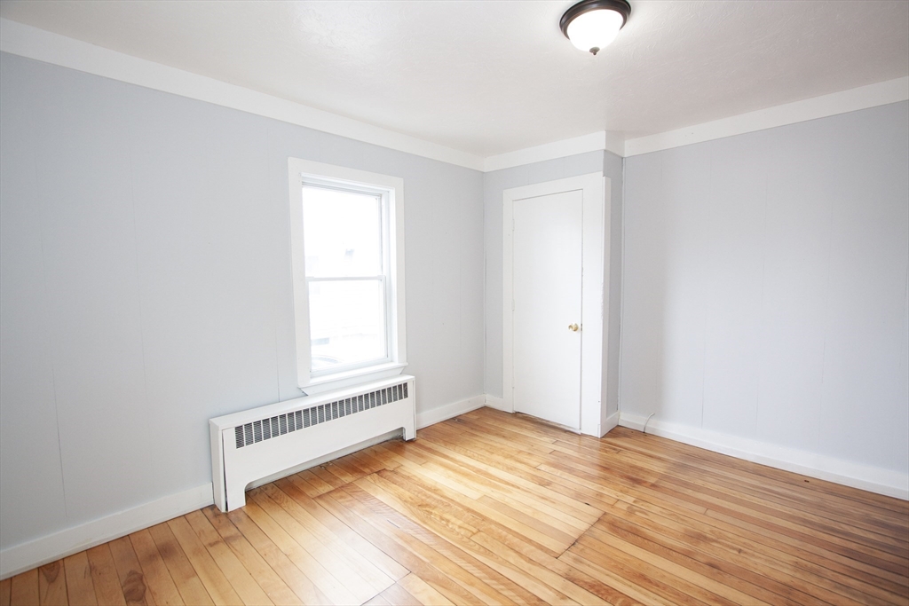 66 Cutler Street Worcester, MA 01604 - Photo 3 of 27 a view of a room with wooden floor and window