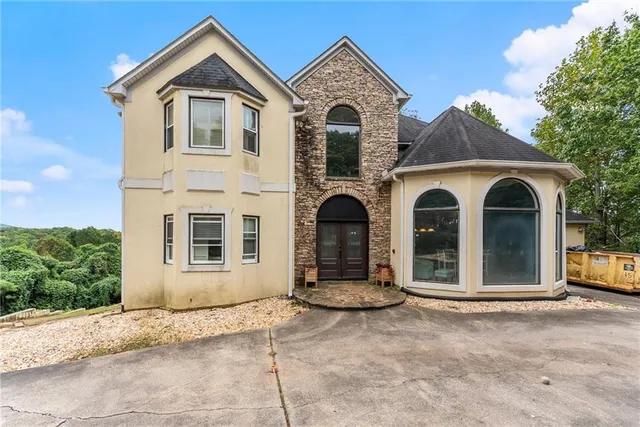 front view of a house with cars parked