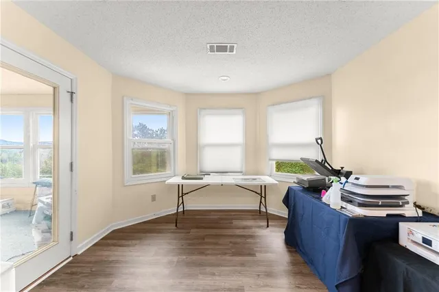 a spacious bedroom with a bed a couch and a chandelier