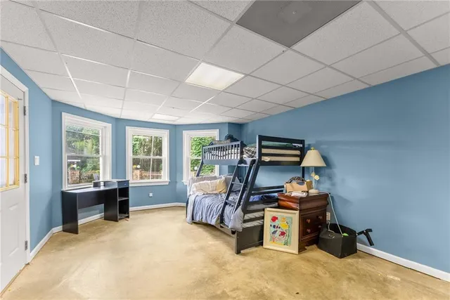 a aerial view of a house with a yard and large trees