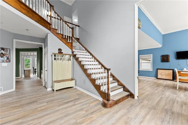 a kitchen with stainless steel appliances granite countertop wooden cabinets a stove a sink and dishwasher with wooden floor