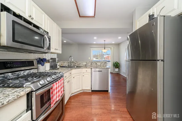 a kitchen with stainless steel appliances granite countertop a refrigerator stove and microwave