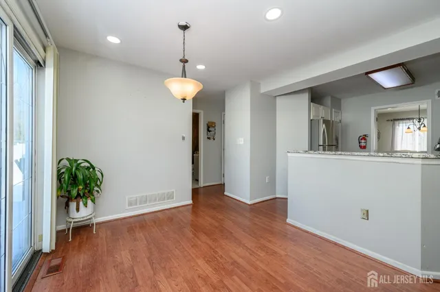 a view of a room with wooden floor and potted plant