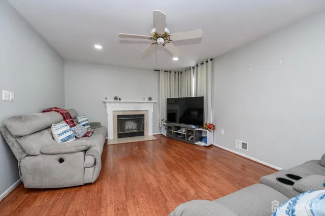 a living room with furniture a fireplace and a flat screen tv