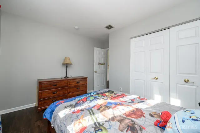 a bedroom with a bed and a dresser