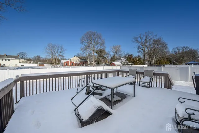 a view of a chairs and table on the roof deck