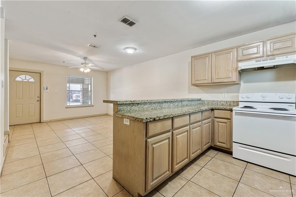 1500 Humming Bird Court, Unit 23 Pharr, TX 78577 - Photo 7 of 26 a kitchen with granite countertop a sink and cabinets