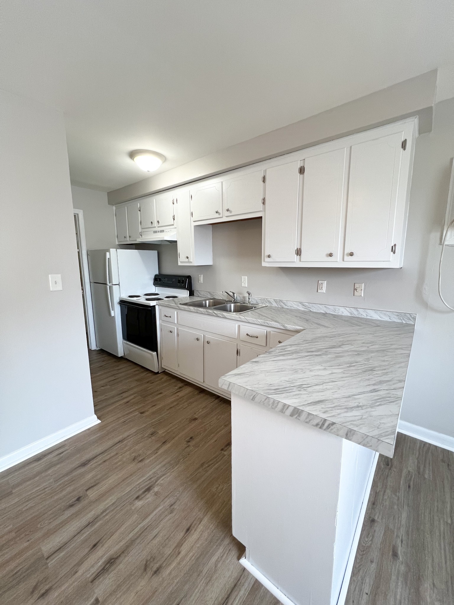 701 Power Street, Unit 1 Clarksville, TN 37042 - Photo 4 of 10 a kitchen with stainless steel appliances granite countertop a white stove top oven sink and cabinets