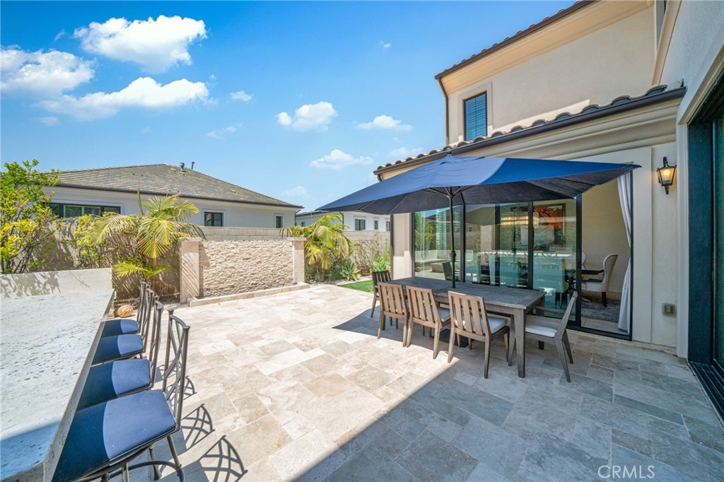 52 Eider Run Irvine, CA 92618 - Photo 7 of 46 a view of a patio with a table and chairs under an umbrella