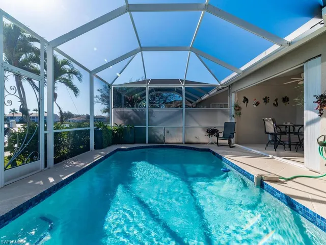 a front view of a house with a yard and potted plants