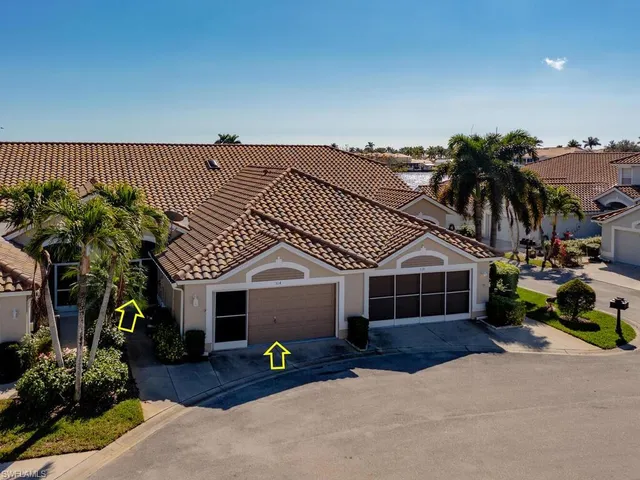 an aerial view of ocean and residential houses with outdoor space