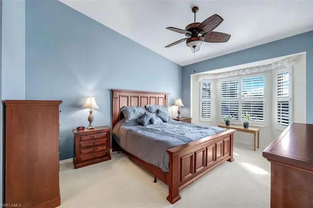 a bedroom with bed and a chandelier