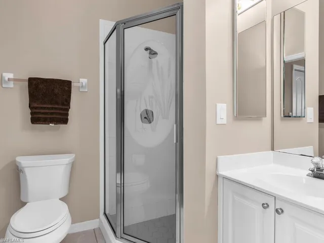 a bathroom with a toilet a sink and shower