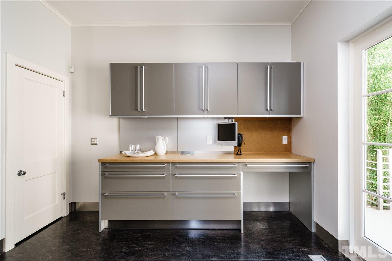 931 Vance Street Raleigh, NC 27608 - Photo 11 of 25 a kitchen with a sink a cabinets and window