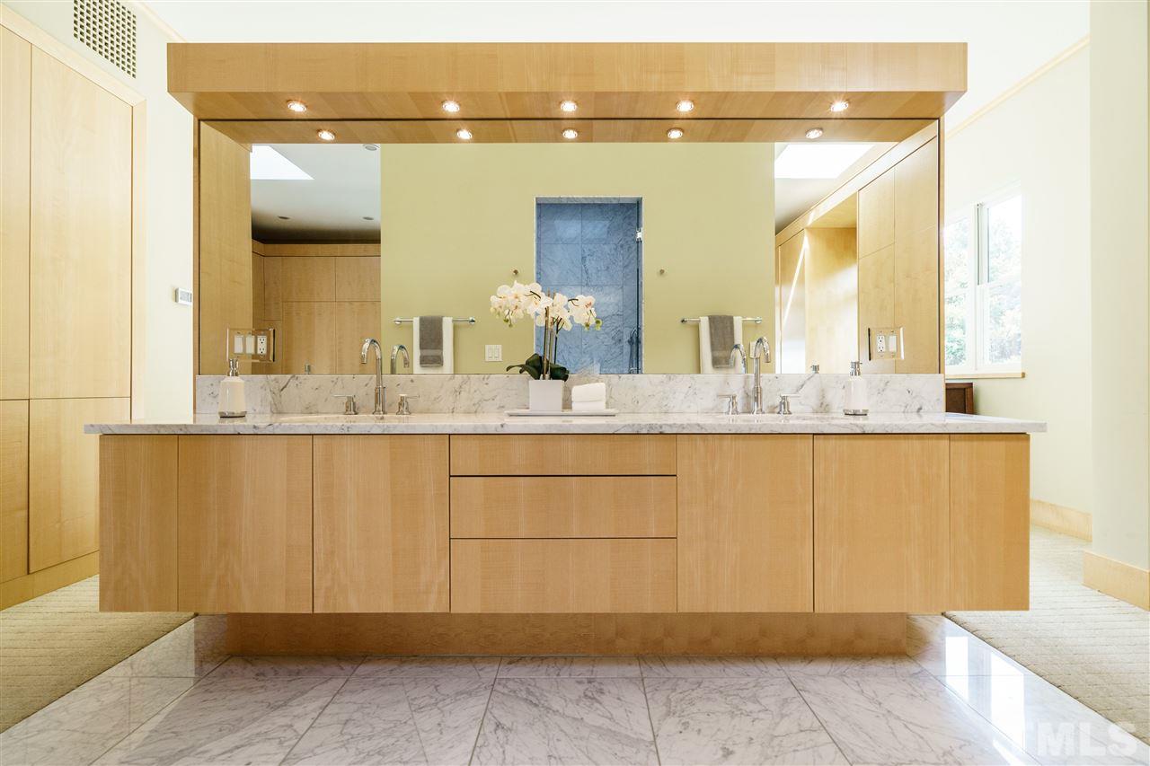931 Vance Street Raleigh, NC 27608 - Photo 14 of 25 a bathroom with a sink and a mirror