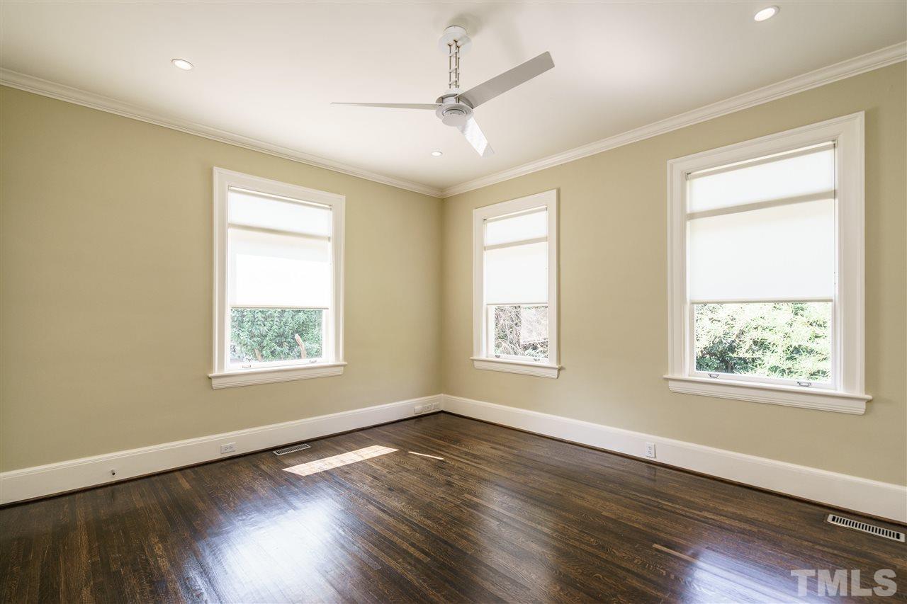931 Vance Street Raleigh, NC 27608 - Photo 17 of 25 a view of an empty room with wooden floor and a window