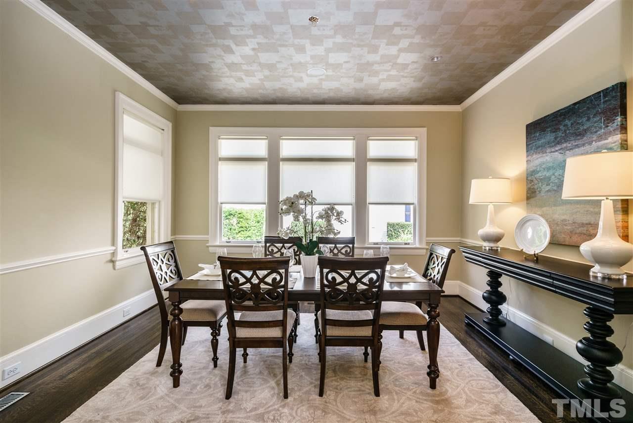 931 Vance Street Raleigh, NC 27608 - Photo 7 of 25 a view of a dining room with furniture a chandelier and wooden floor