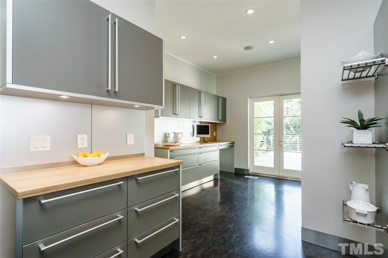931 Vance Street Raleigh, NC 27608 - Photo 10 of 25 a kitchen with a sink dishwasher stove and wooden floor