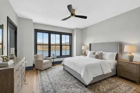 a bedroom with a bed a couch and a window