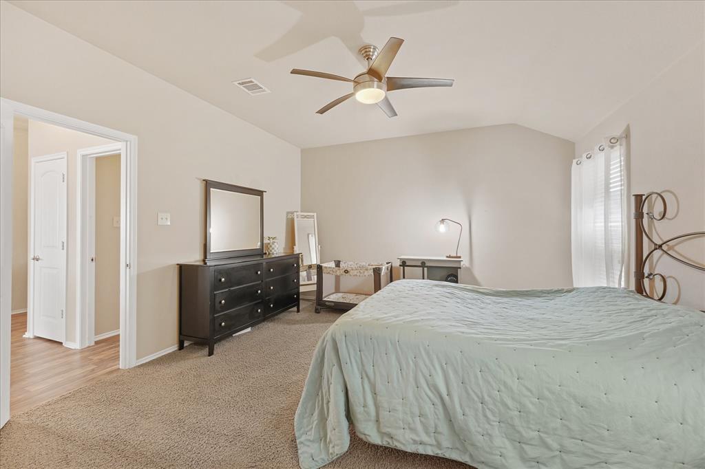 409 Harding Lane Lavon, TX 75166 - Photo 11 of 34 Carpeted room featuring a vaulted ceiling and a ceiling fan with integrated lighting