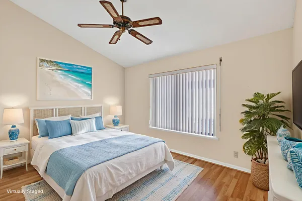 a bedroom with a large bed and a potted plant