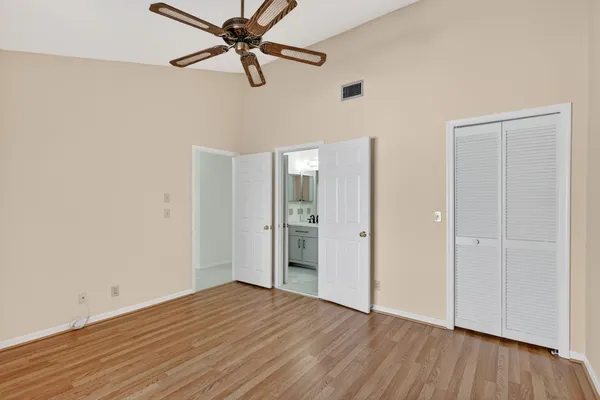 a view of empty room with wooden floor