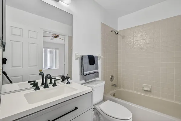 a bathroom with a sink toilet tub and shower