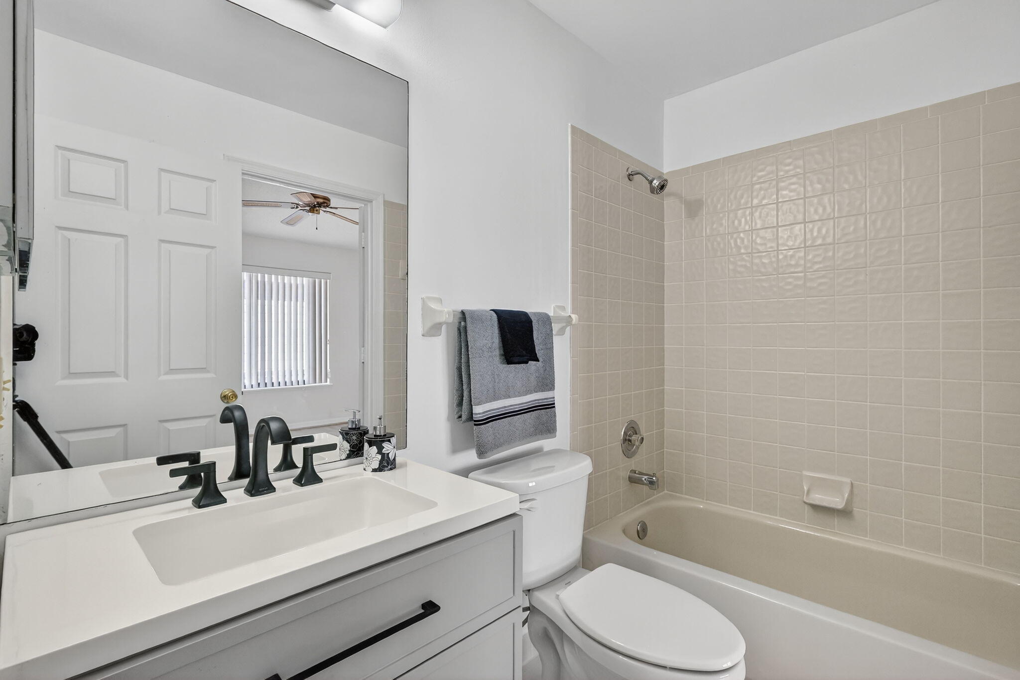 6184 Southeast Georgetown Place Hobe Sound, FL 33455 - Photo 18 of 29 a bathroom with a sink toilet tub and shower
