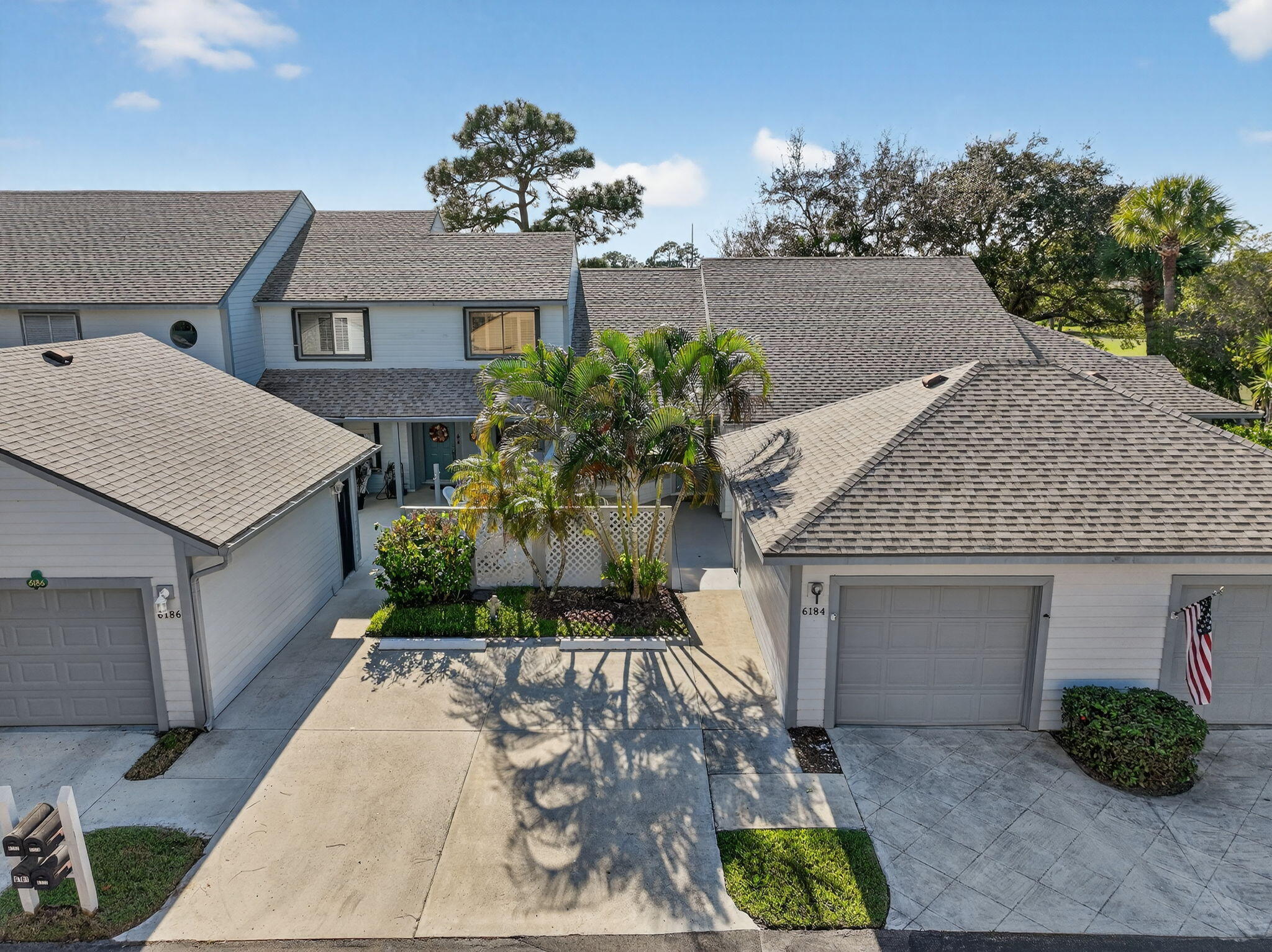 6184 Southeast Georgetown Place Hobe Sound, FL 33455 - Photo 2 of 29 a front view of a house with garden