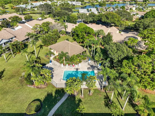 an aerial view of a residential houses with yard
