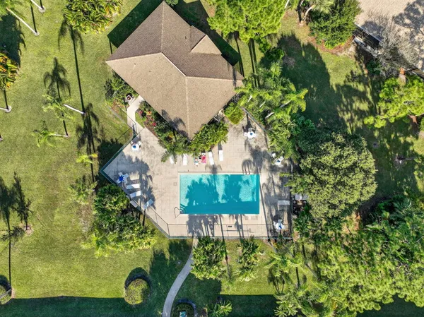 an aerial view of a house with a yard and garden