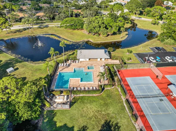 an aerial view of residential houses with outdoor space and swimming pool