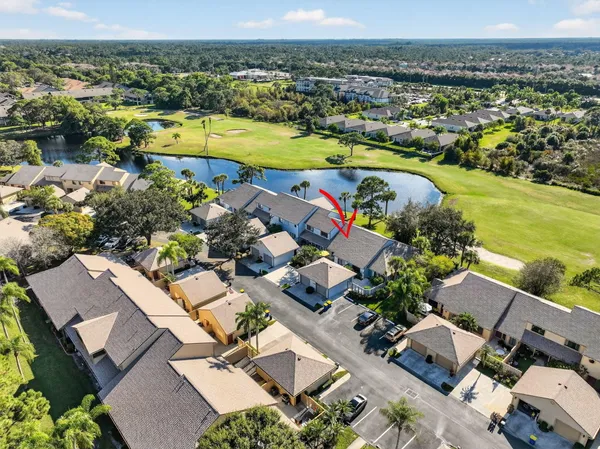 an aerial view of a house with a swimming pool a yard and mountain view in back